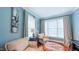 Blue living room features comfortable seating, large windows, and built-in entertainment center at 3197 Carriage Creek Ct, Haw River, NC 27258