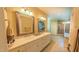 Well-lit main bathroom with double vanity, tiled floors, and glass shower at 3197 Carriage Creek Ct, Haw River, NC 27258