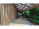 Outbuilding offers a covered walkway with rocking chairs, connecting to lush greenery at 3197 Carriage Creek Ct, Haw River, NC 27258