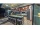 Covered outdoor bar area with stone counter, bar stools, and built-in cabinetry at 3197 Carriage Creek Ct, Haw River, NC 27258