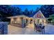Charming outdoor kitchen and dining area with bar seating, perfect for entertaining guests by the pool at 3197 Carriage Creek Ct, Haw River, NC 27258