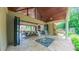 Inviting outdoor patio with rocking chairs and an open view to the indoor dining area at 3197 Carriage Creek Ct, Haw River, NC 27258