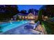Serene poolside view with lounge chairs, highlighting the in-ground pool and manicured landscaping at twilight at 3197 Carriage Creek Ct, Haw River, NC 27258
