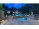 Stunning backyard pool and hot tub featuring stone accents and steps leading to a spacious deck area at 3197 Carriage Creek Ct, Haw River, NC 27258