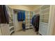 A well-organized walk-in closet provides ample storage space with shelving and hanging racks at 3197 Carriage Creek Ct, Haw River, NC 27258