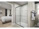 Bathroom featuring glass enclosed walk-in shower, with a view into the adjacent bedroom at 32 Elmwood Ave, Sanford, NC 27330