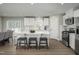Open kitchen featuring white cabinetry, stainless steel appliances, and an island with bar seating at 32 Elmwood Ave, Sanford, NC 27330
