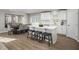 Well-lit kitchen and dining area featuring a large island with bar stools and hardwood floors at 32 Elmwood Ave, Sanford, NC 27330