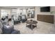 Cozy living room featuring modern furniture, hardwood floors, and a view into the kitchen and dining area at 32 Elmwood Ave, Sanford, NC 27330