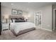 Inviting main bedroom with soft lighting, plush bedding, ensuite bathroom, and carpeted floors at 32 Elmwood Ave, Sanford, NC 27330