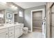Modern bathroom with a double sink vanity, a walk-in shower, and stylish gray tiling at 33 Elmwood Ave, Sanford, NC 27330