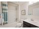 Bright, all white bathroom with a shower/tub combo and a dark vanity with a white sink at 33 Elmwood Ave, Sanford, NC 27330