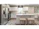 Well-lit kitchen with stainless steel appliances, white cabinets, and an island with comfortable bar stools at 33 Elmwood Ave, Sanford, NC 27330