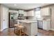 Bright kitchen with stainless steel appliances, an island with seating, and white cabinetry at 33 Elmwood Ave, Sanford, NC 27330