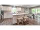 Modern kitchen featuring stainless steel appliances, an island with stools, and a dining area at 33 Elmwood Ave, Sanford, NC 27330