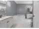 Well-lit bathroom featuring a corner tub, double vanity, and black-and-white tiled flooring at 3841 Rawls Church Rd, Fuquay Varina, NC 27526