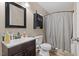 Bathroom featuring a shower with curtains, a black framed mirror and a wooden sink at 3841 Rawls Church Rd, Fuquay Varina, NC 27526
