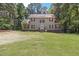Charming two-story home with a well-maintained lawn and a welcoming front porch and set among many trees at 3841 Rawls Church Rd, Fuquay Varina, NC 27526