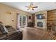 Cozy living room with a stone fireplace and wood-paneled accent wall, perfect for relaxing and entertaining at 3841 Rawls Church Rd, Fuquay Varina, NC 27526