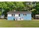 Cozy single-Gathering home showcasing painted blue brick and a well-maintained lawn at 403 S Webb St, Selma, NC 27576