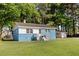 Charming one-story home with blue painted brick and a large, green lawn at 403 S Webb St, Selma, NC 27576