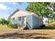 Rear view of a one story home featuring painted blue brick exterior and white trim at 403 S Webb St, Selma, NC 27576