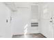 Bright laundry room with white walls, utility hookups, and access to the exterior at 403 S Webb St, Selma, NC 27576
