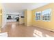 Open-concept living room area with great natural light and light wood flooring at 403 S Webb St, Selma, NC 27576