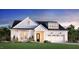 Charming new construction featuring board and batten siding, dormer windows, and a two-car garage at 405 Mugby Rd # 153, Raleigh, NC 27610