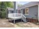 Charming backyard featuring a deck with access to the home, set against a backdrop of lush trees at 5008 Dantonville Ct, Knightdale, NC 27545