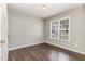 Cozy bedroom featuring a large window and stylish laminate wood flooring at 5008 Dantonville Ct, Knightdale, NC 27545