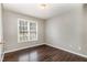 Bedroom featuring neutral paint, stylish flooring, and a bright window at 5008 Dantonville Ct, Knightdale, NC 27545