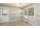 Dining area with a modern chandelier and large window, offering bright and comfortable dining at 5008 Dantonville Ct, Knightdale, NC 27545