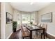Bright dining room featuring a bay window for ample natural light and modern table setting at 5008 Dantonville Ct, Knightdale, NC 27545