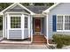 Close-up of a well-kept home featuring a bright red front door, complementing the exterior at 5008 Dantonville Ct, Knightdale, NC 27545