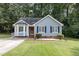 Charming single-Gathering home with blue siding, landscaped yard, and classic architectural details at 5008 Dantonville Ct, Knightdale, NC 27545