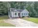 Inviting home featuring a well-manicured lawn, driveway, and beautiful light-blue exterior at 5008 Dantonville Ct, Knightdale, NC 27545