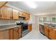 Well-equipped kitchen with stainless steel appliances, wood cabinets and easy access to dining area at 5008 Dantonville Ct, Knightdale, NC 27545