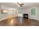 Open-concept living room with hardwood floors, fireplace, and natural light from the backyard at 5008 Dantonville Ct, Knightdale, NC 27545