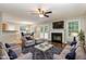 Inviting living room featuring a fireplace, ceiling fan and ample natural light from windows and french doors at 5008 Dantonville Ct, Knightdale, NC 27545