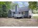 View of the house with an upper deck, blue siding, gray roof, and a chimney at 5008 Dantonville Ct, Knightdale, NC 27545