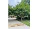 Long driveway leading to a home with manicured landscaping and mature shade trees at 5205 Newstead Manor Ln, Raleigh, NC 27606