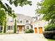 Stunning stone and brick home with a three-car garage and beautifully landscaped front yard at 5205 Newstead Manor Ln, Raleigh, NC 27606