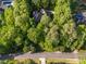 Secluded estate nestled amidst lush greenery with winding driveway at 540 Vista Del Lago Ln, Wake Forest, NC 27587