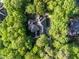 Aerial view showcasing a large private home surrounded by green mature trees at 540 Vista Del Lago Ln, Wake Forest, NC 27587