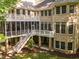 Backyard of a brick home featuring multiple levels, a screen porch and an outdoor patio at 540 Vista Del Lago Ln, Wake Forest, NC 27587