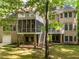 A two-story brick home featuring a backyard with a large screen porch and patio at 540 Vista Del Lago Ln, Wake Forest, NC 27587