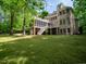 Large backyard with view of a brick home and a screened in porch and balcony at 540 Vista Del Lago Ln, Wake Forest, NC 27587