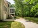 Expansive backyard view of brick home featuring a screened porch, balcony, and luscious lawn at 540 Vista Del Lago Ln, Wake Forest, NC 27587