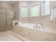 Luxurious bathroom with a soaking tub, separate shower, and tile flooring with decorative inlays at 540 Vista Del Lago Ln, Wake Forest, NC 27587